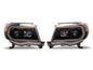 Raxiom 05-11 ToyotaTacoma Axial Series Switchback Projector Headlights- Black Housing- Clear Lens
