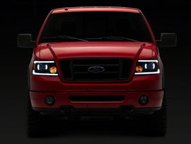 Raxiom 04-08 Ford F-150 Axial Series Projector Headlights with LED Bar- Black Housing- Clear Lens