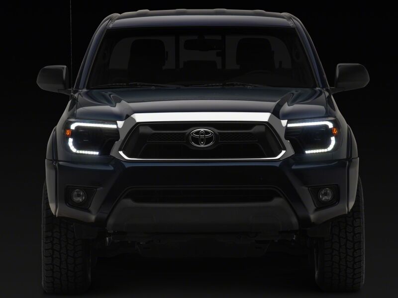 Raxiom 12-15 ToyotaTacoma Axial Series Switchback Projector Headlights- Black Housing- Clear Lens