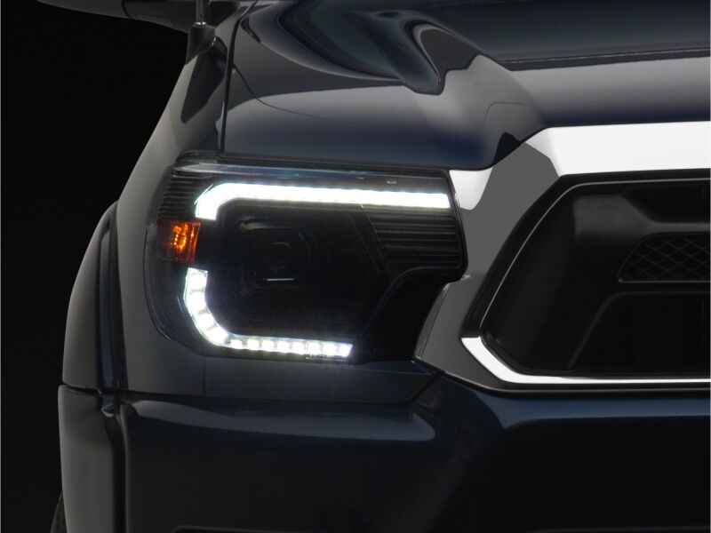 Raxiom 12-15 ToyotaTacoma Axial Series Switchback Projector Headlights- Black Housing- Clear Lens