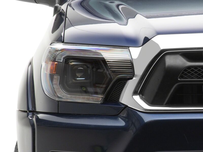 Raxiom 12-15 ToyotaTacoma Axial Series Switchback Projector Headlights- Black Housing- Clear Lens